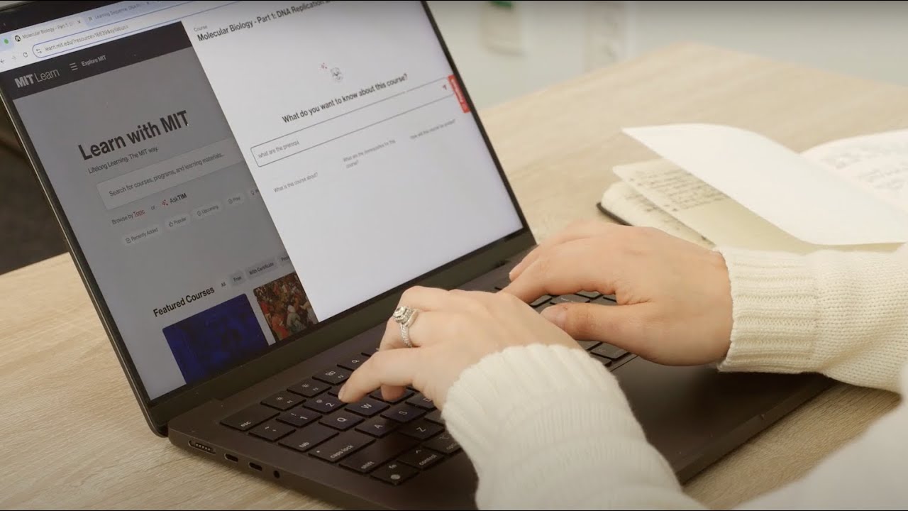 Hands typing on a laptop displaying the MIT Learn homepage